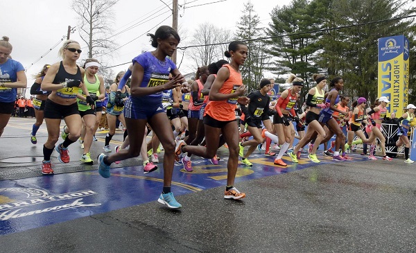 Runners cross the start line in the women's division of Boston Marathon Monday, April 20, 2015 in Hopkinton, Mass. (AP Photo/Stephan Savoia)