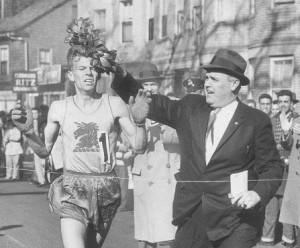 BOSTON - APRIL 20: John J. Kelley is presented the winners wreath by John Melia in the 1957 marathon. (Photo by Jack Sheahan/The Boston Globe via Getty Images)